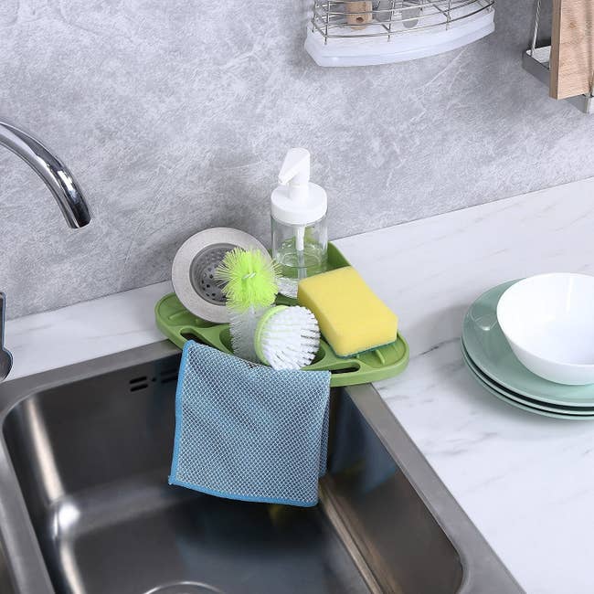 kitchen sink with triangle shaped sponge and soap holder on the corner of a sink 