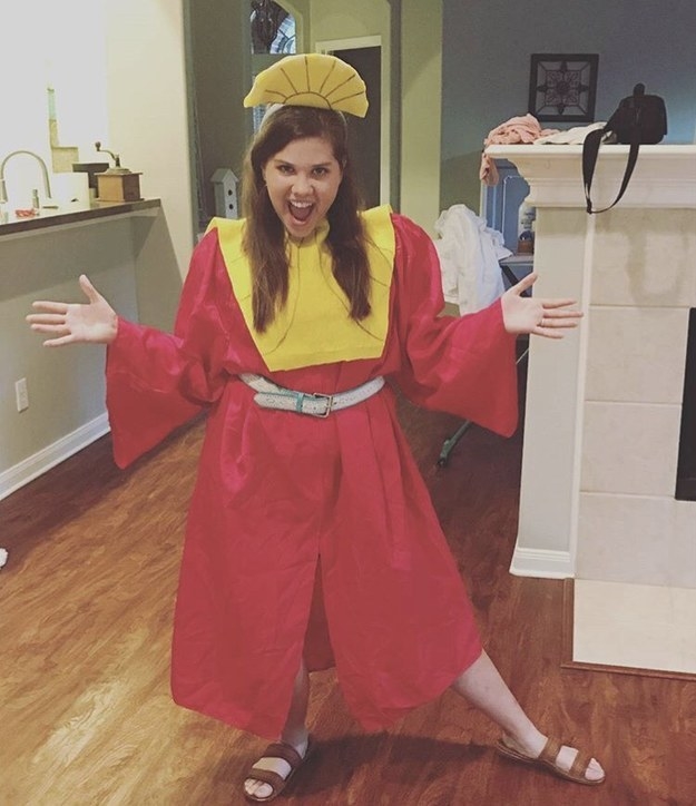 girl in a red robe and yellow headpiece