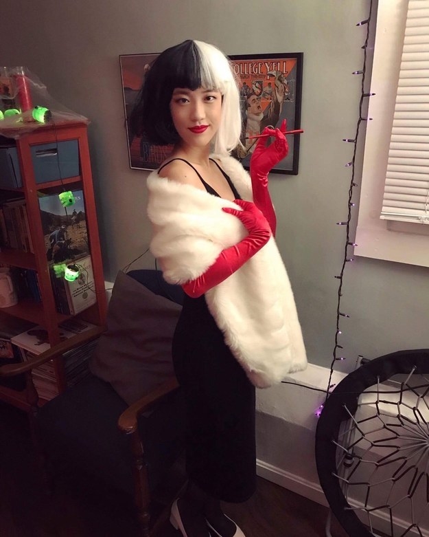 girl in a black and white wig with a long cigarette holder