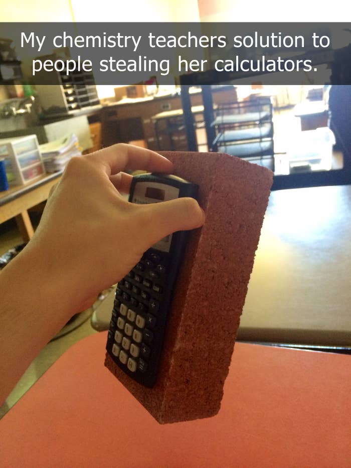 A hand holding a brick with a calculator attached to it in a classroom setting. Text on the image reads, &quot;My chemistry teacher&#x27;s solution to people stealing her calculators.&quot;