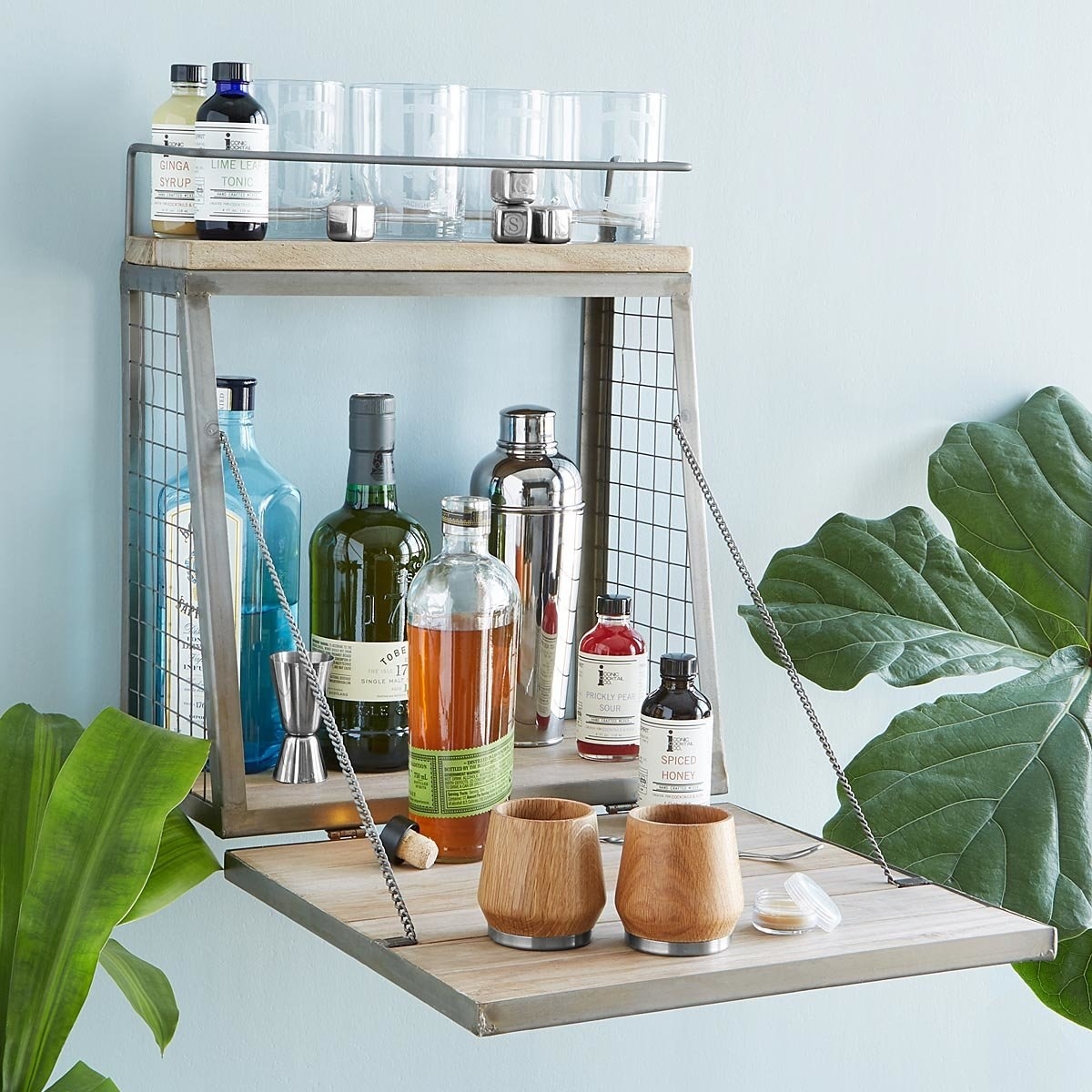 the fold down drink station styled with different bottles and cups