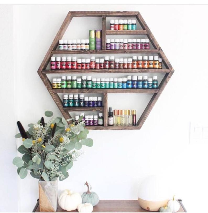 wood shelf shaped like a hexagon holding tons of essential oil bottles