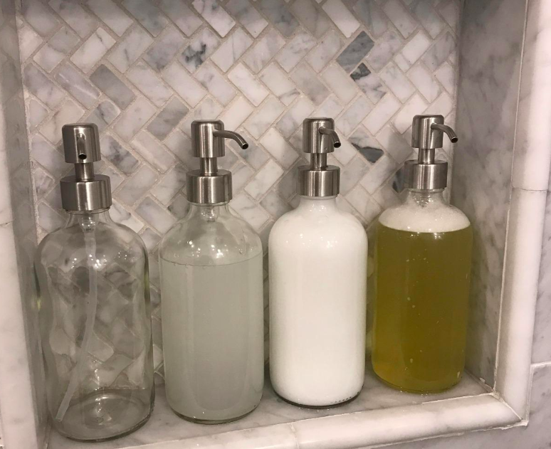 A customer review photo of four soap dispensers in their shower.  