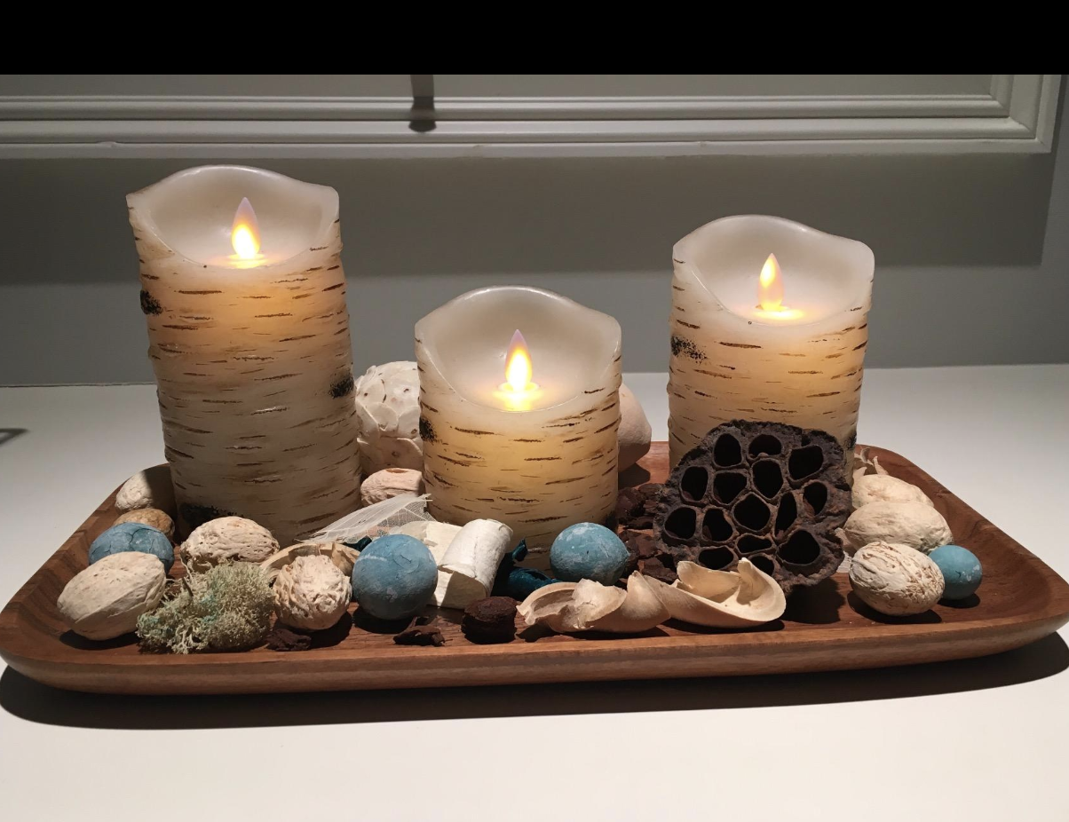 The candle set in a decorative tray