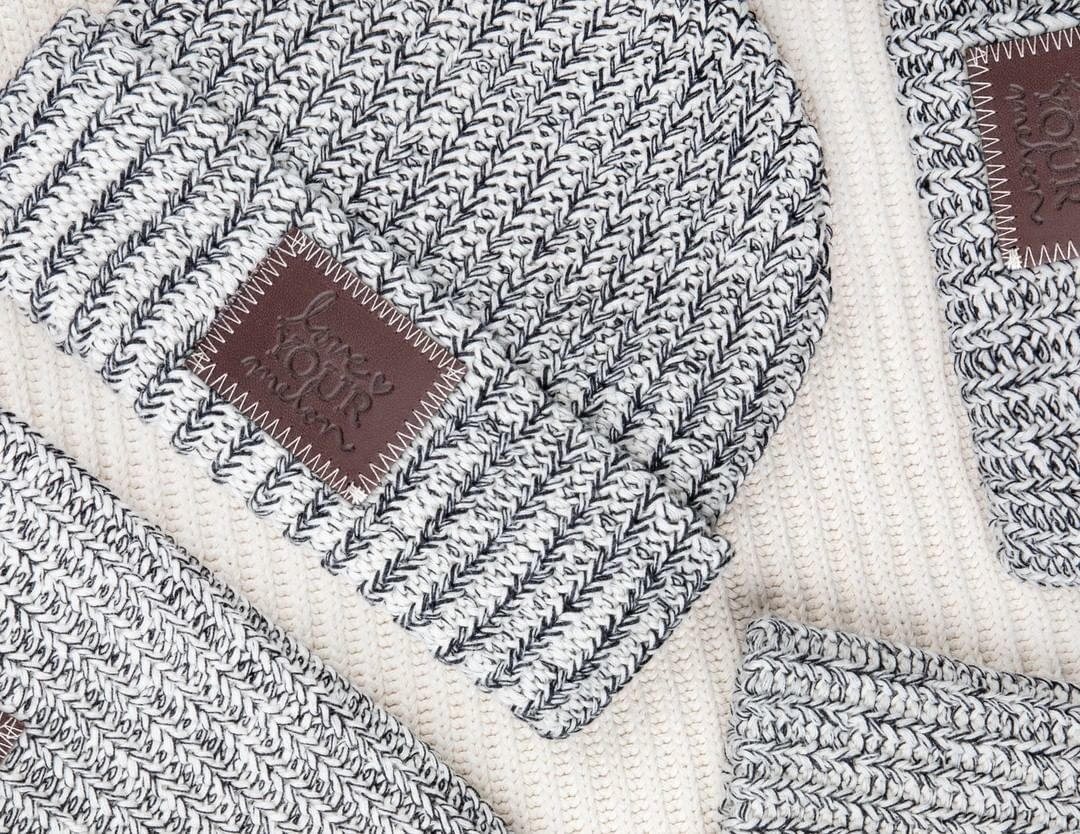 a grey and white speckled beanie
