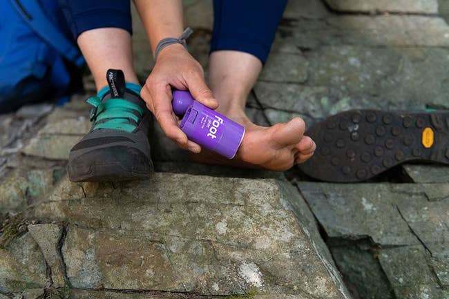 closeup of person applying product to their foot