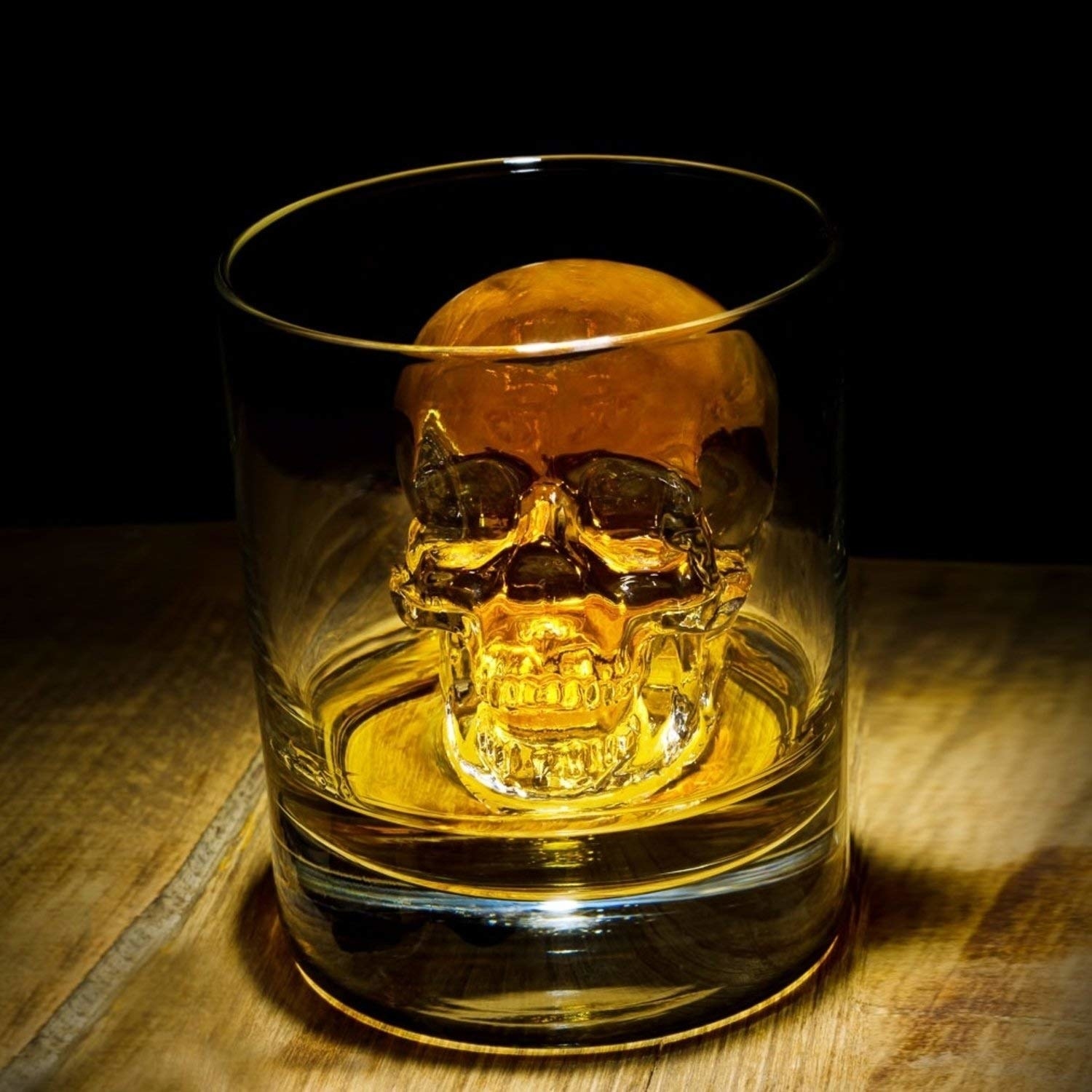 a glass with an ice cube shaped like a skeleton in it