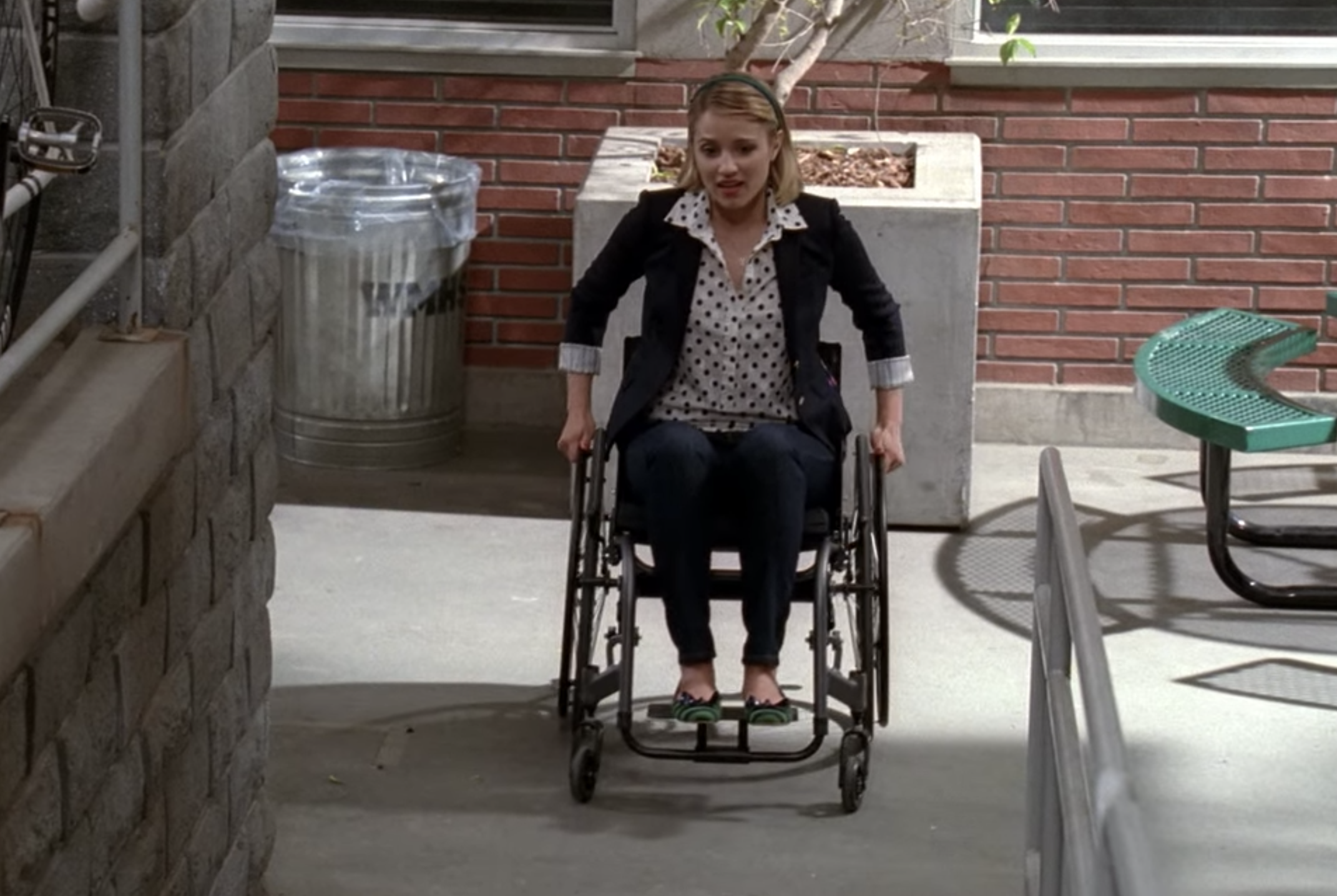 Quinn in a wheelchair going up a ramp