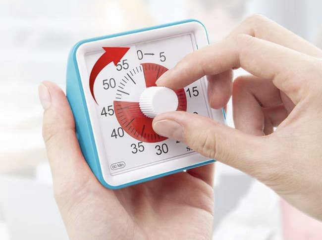 A model adjusting the time on the small square clock 