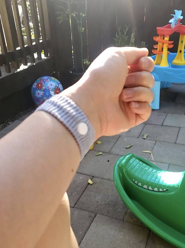 Reviewer with gray band on their wrist 