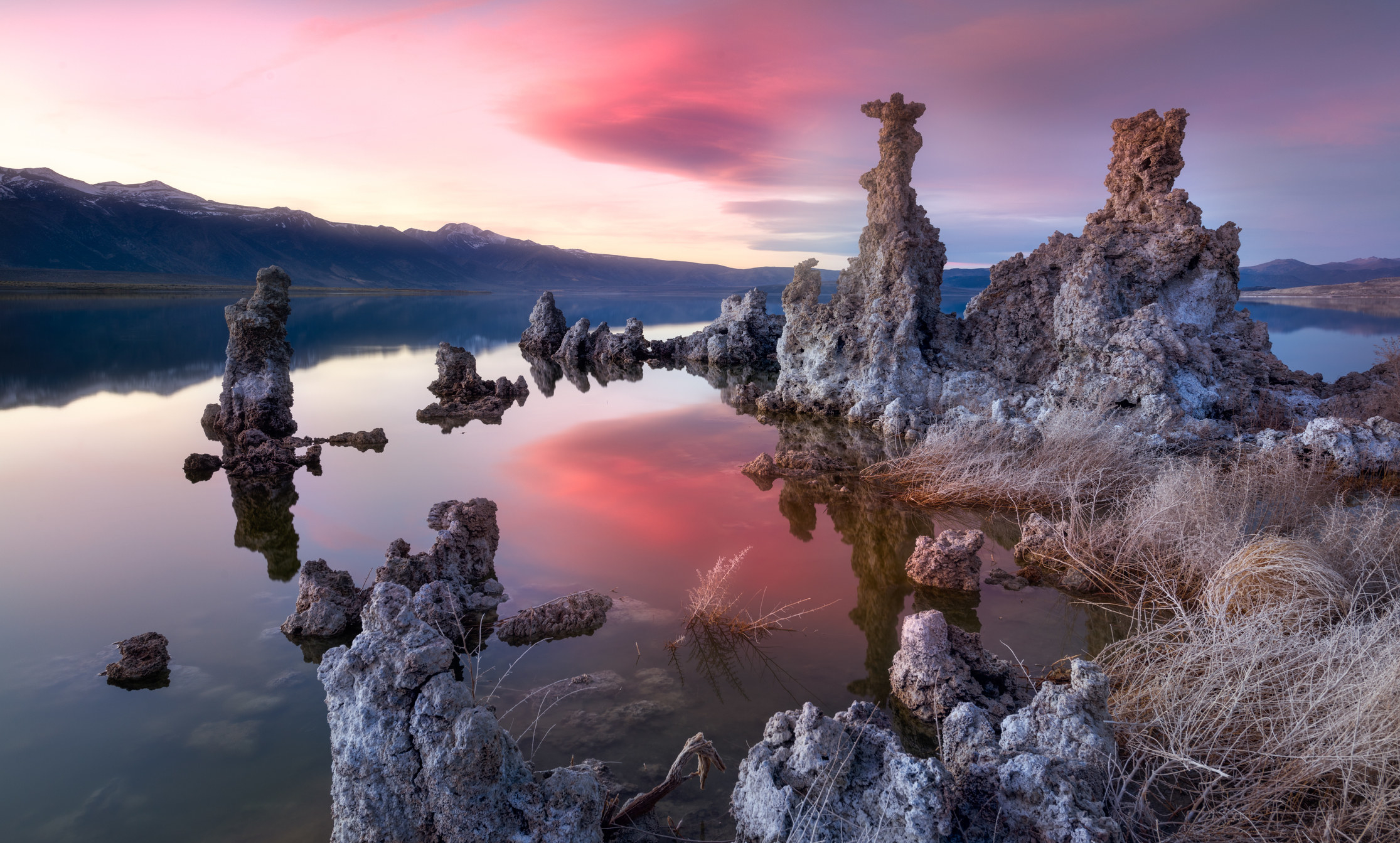 A sunset view of a serene lake and unique limestone formations