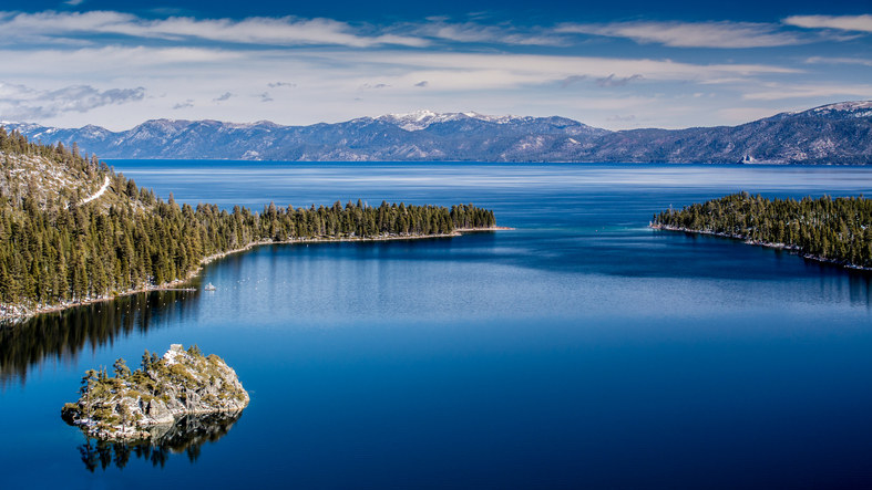 A picturesque view of the vast lake and surrounding woods.