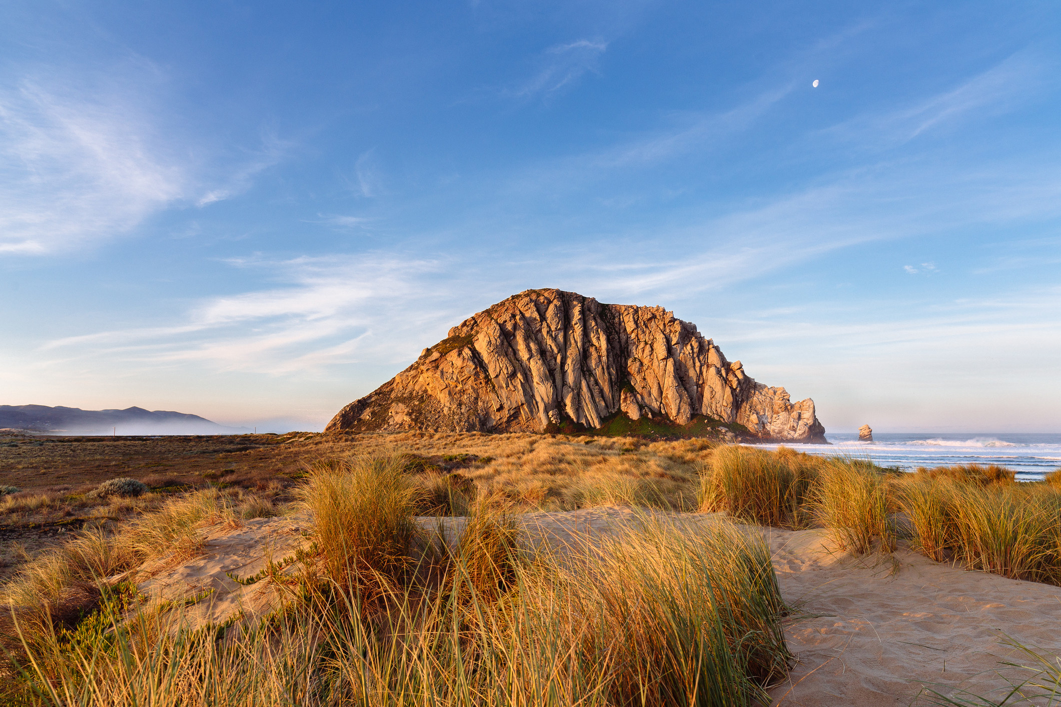 A large rock formation by the beach.