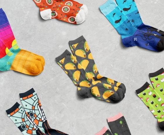 A collection of printed socks, including a taco-print socks, sushi-print socks, and rocket socks