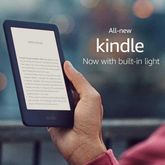 A hand holding a Kindle