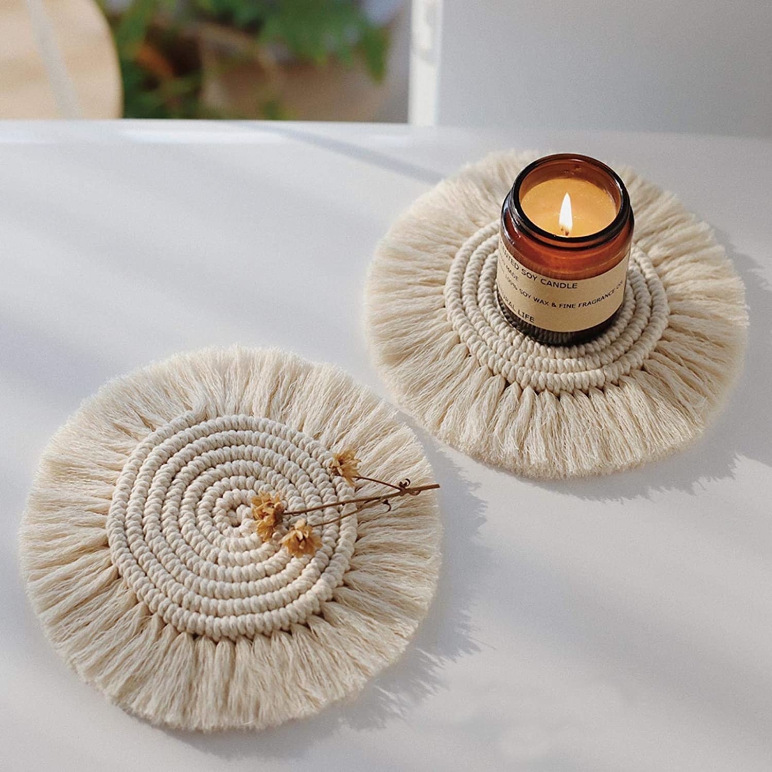 Two of the cream macrame coasters