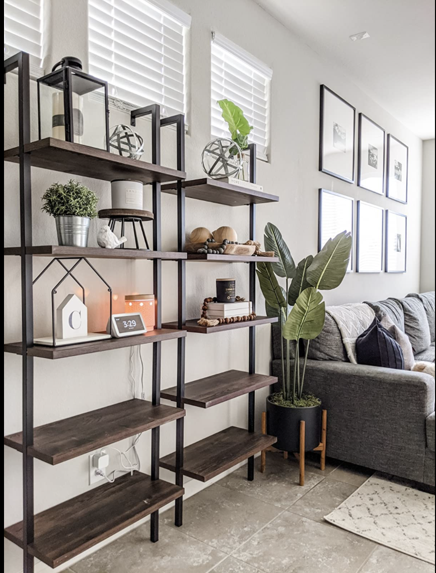 Two of the ladder shelves in brown and black are next to each other