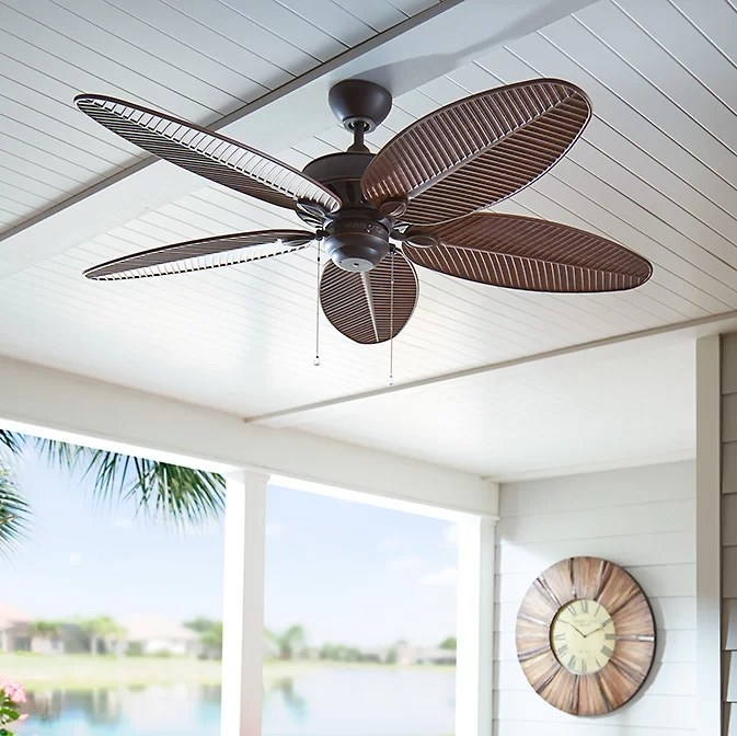 The brown fan hanging from a porch ceiling