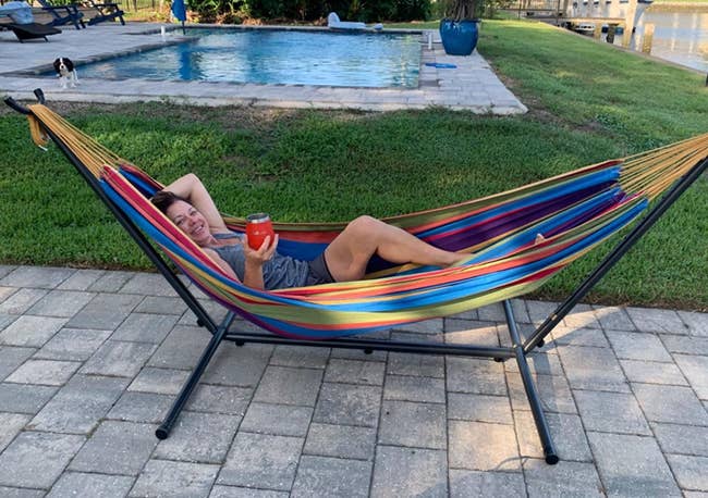 Reviewer sitting in hammock by pool