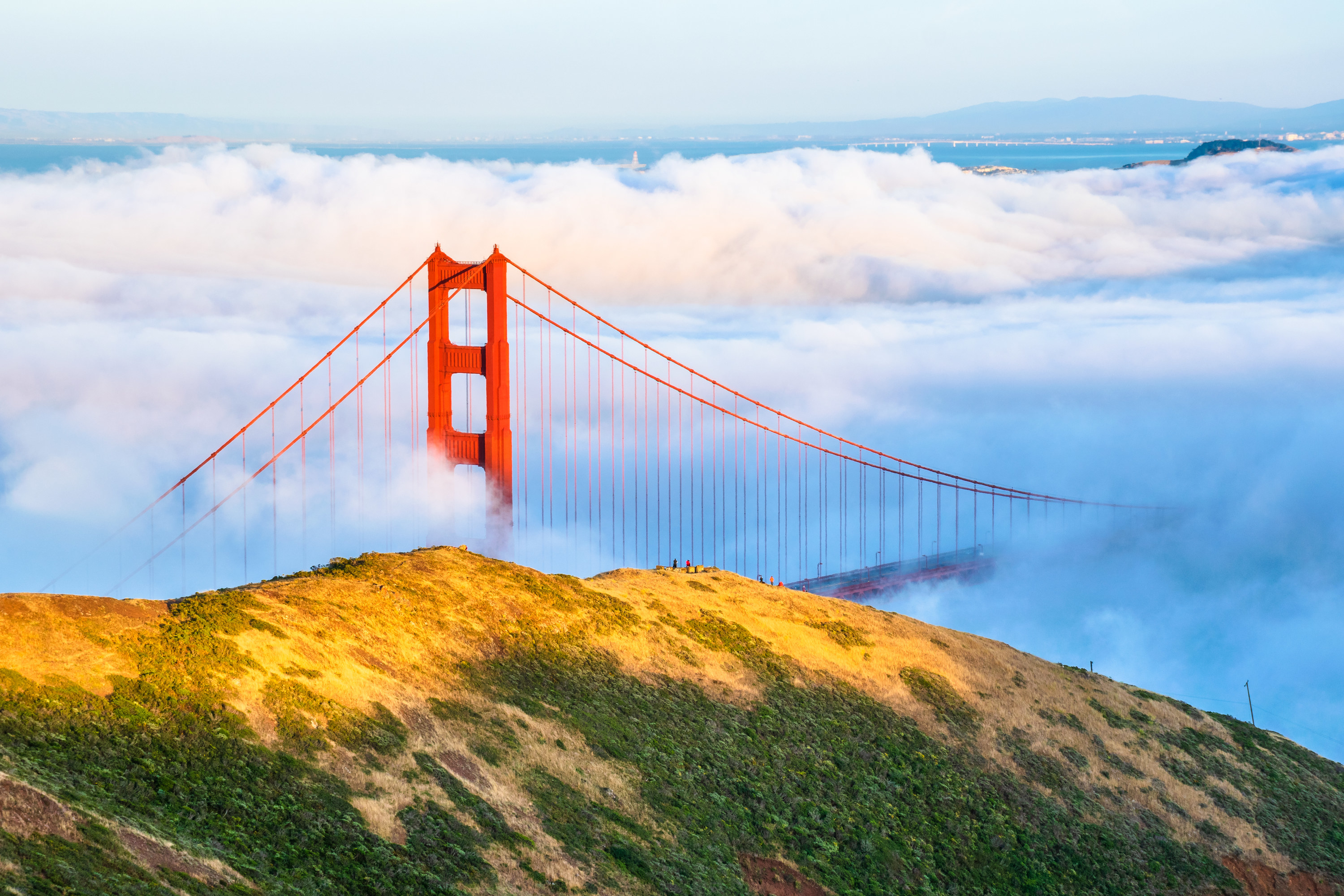Fog flowing across the Golden Gate Bridge as seen from the Marin Headlands in San Francisco, California.
