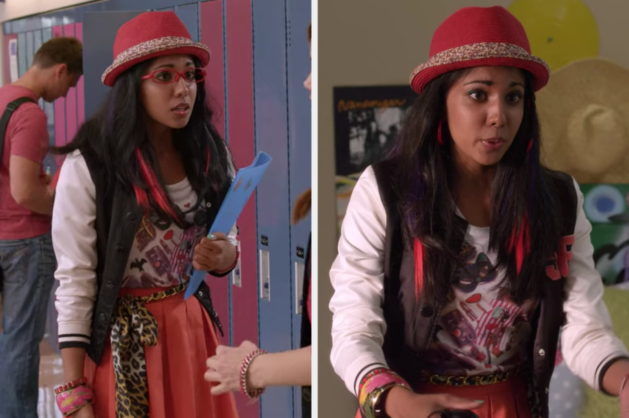 Audrey wearing a skater skirt, varsity jacket, leopard belt, fedora, and pink hair extensions