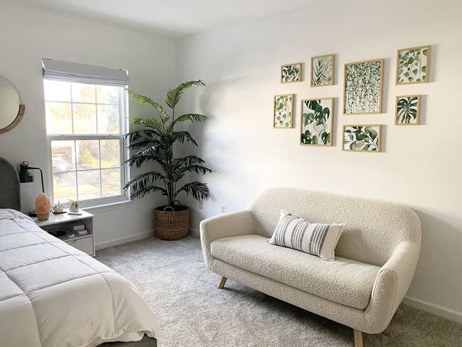 Reviewer's bedroom shows the prints above a small sofa