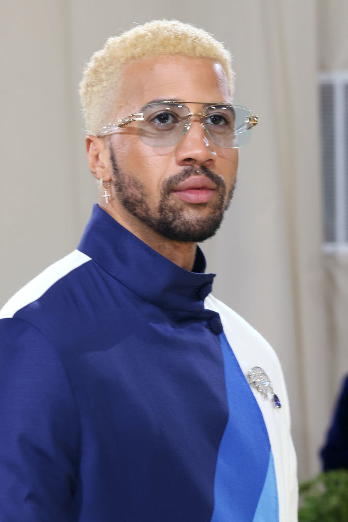 A close up of Miles Chamley-Watson as he shows off his translucent sunglasses