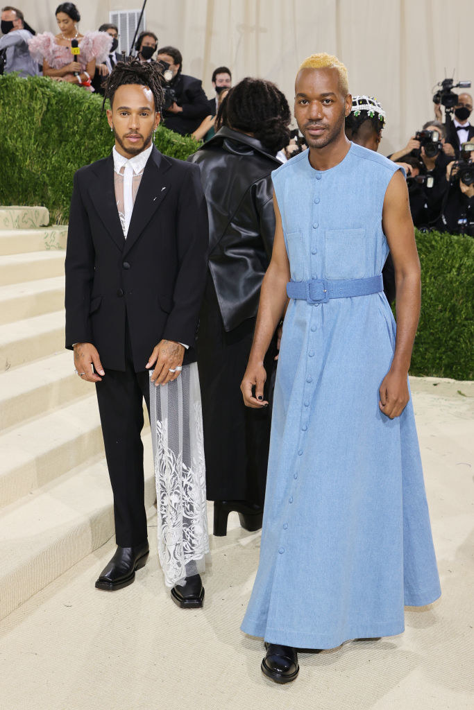 Kenneth Nicholson wears a floor length sleeveless brightly colored gown