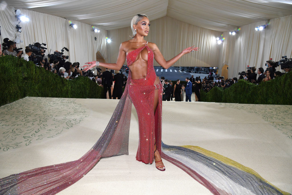 Saweetie wears a gown with a cut out on her torso with a long train