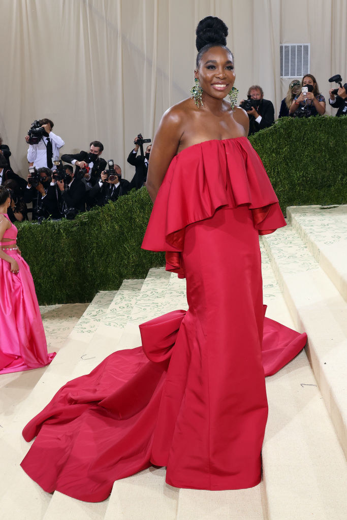 Venus Williams wears a strapless brightly colored gown with a long train