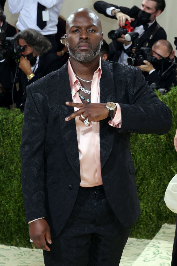 A close up of Corey Gamble as he throws a peace sign up at the camera