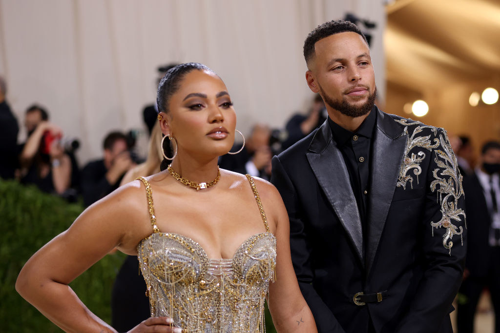A close up of Ayesha Curry as she poses next to her husband, Stephen