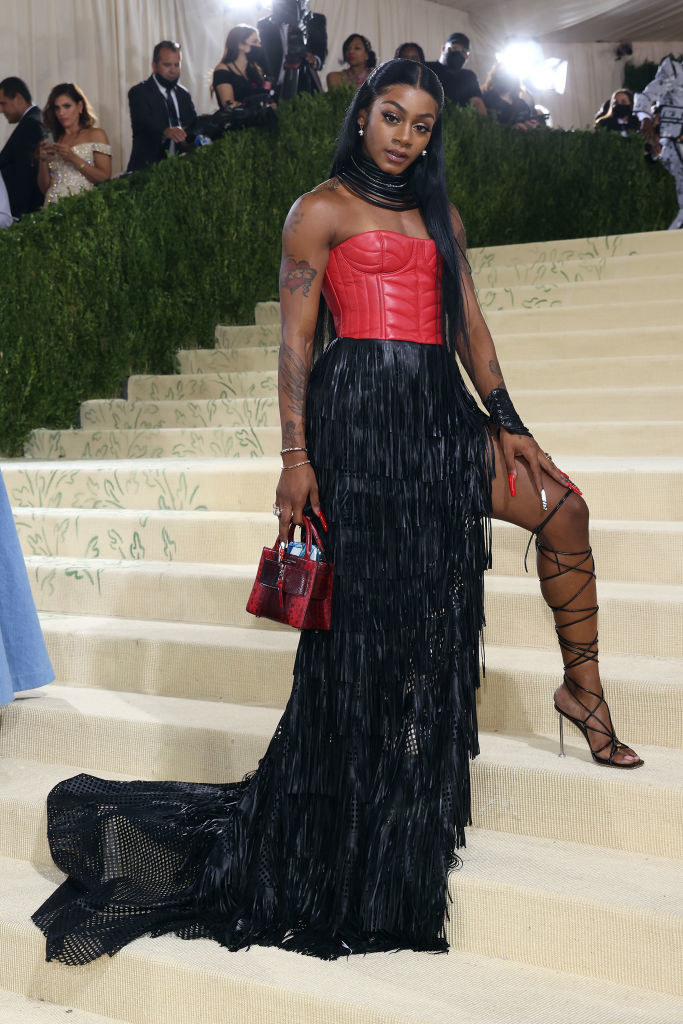 Sha&#x27;Carri Richardson wears a strapless gown floor length gown with a slit up the thigh