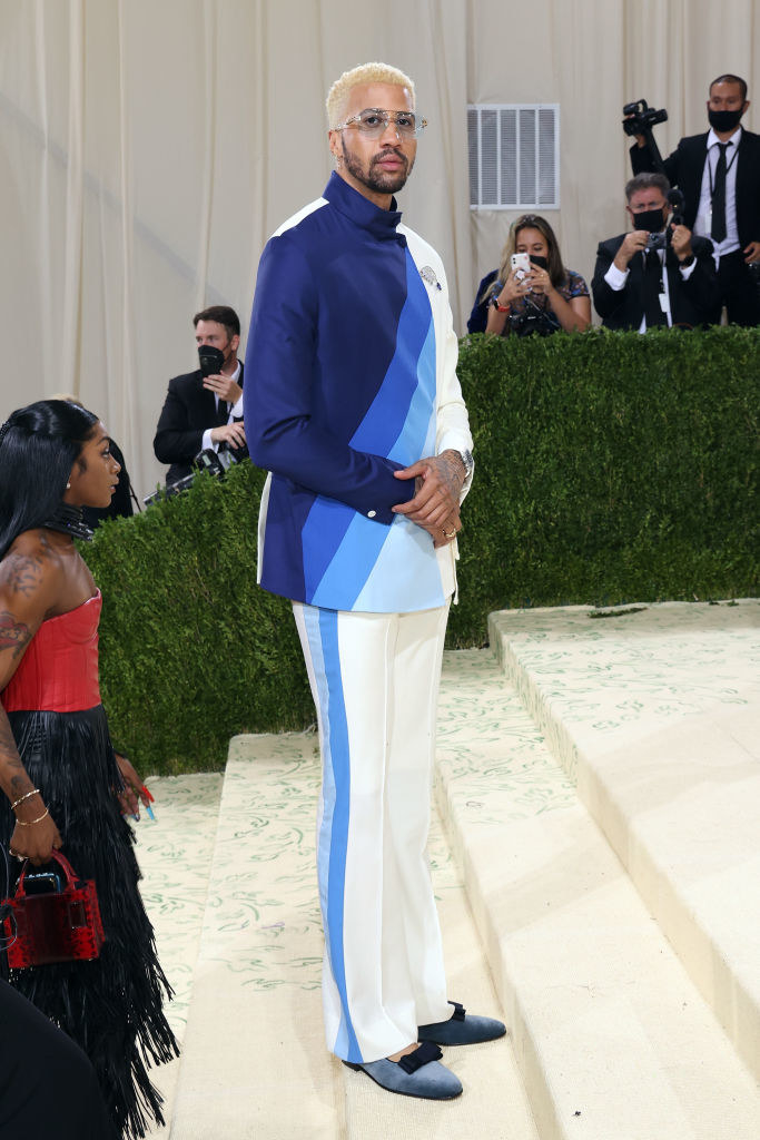 Miles Chamley-Watson wears a brightly patterned suit jacket and matching slacks