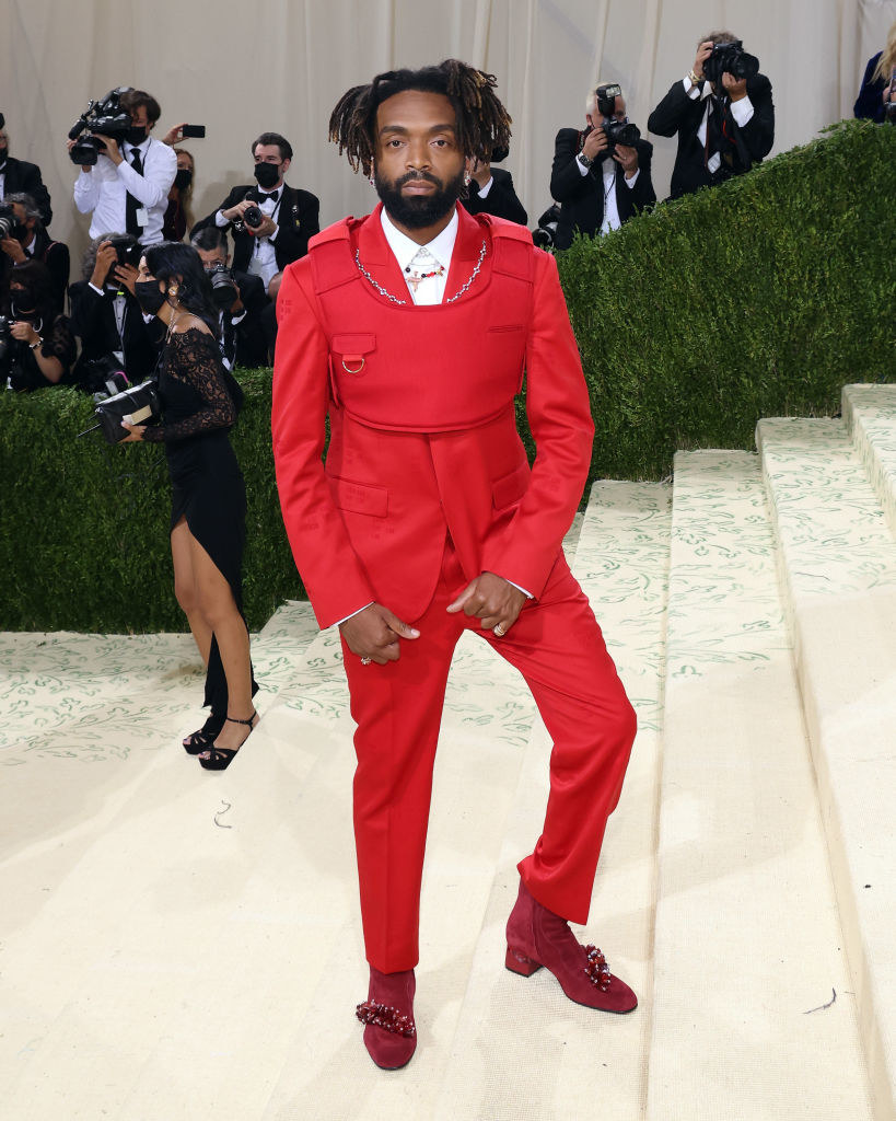 Kerby-Jean Raymond wears a brightly colored suit underneath a matching cropped bulletproof vest