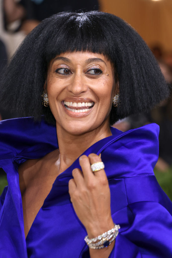 A close up of Tracee Ellis Ross as she smiles and poses while looking over her shoulder