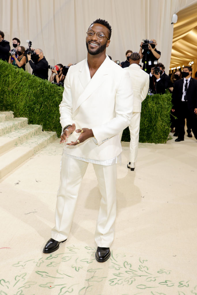 Aldis Hodge wears a light colored suit and matching slacks