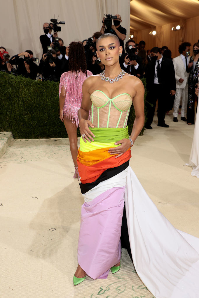 Jordan Alexander wears a strapless neon colored bodice tucked into a skirt that has multiple colors in it