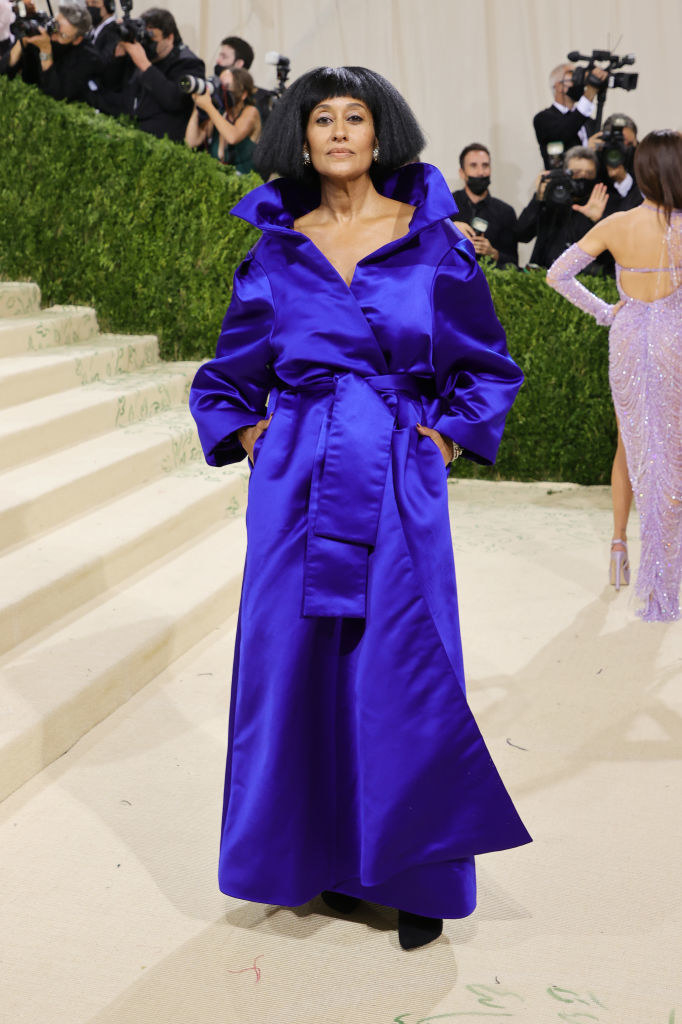 Tracee Ellis Ross wears a long sleeve high collared brightly colored gown