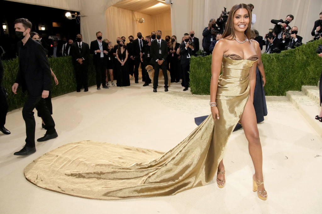 Leyna Bloom wears a strapless shiny gown with a long train