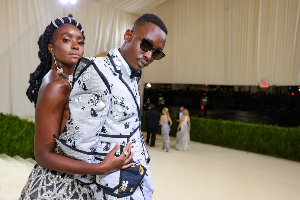 A close up of KiKi Layne and Ashton Sanders as she hugs him from behind