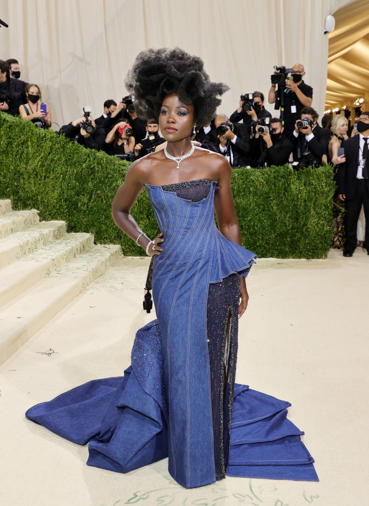 Lupita Nyong&#x27;o wears a long denim strapless gown