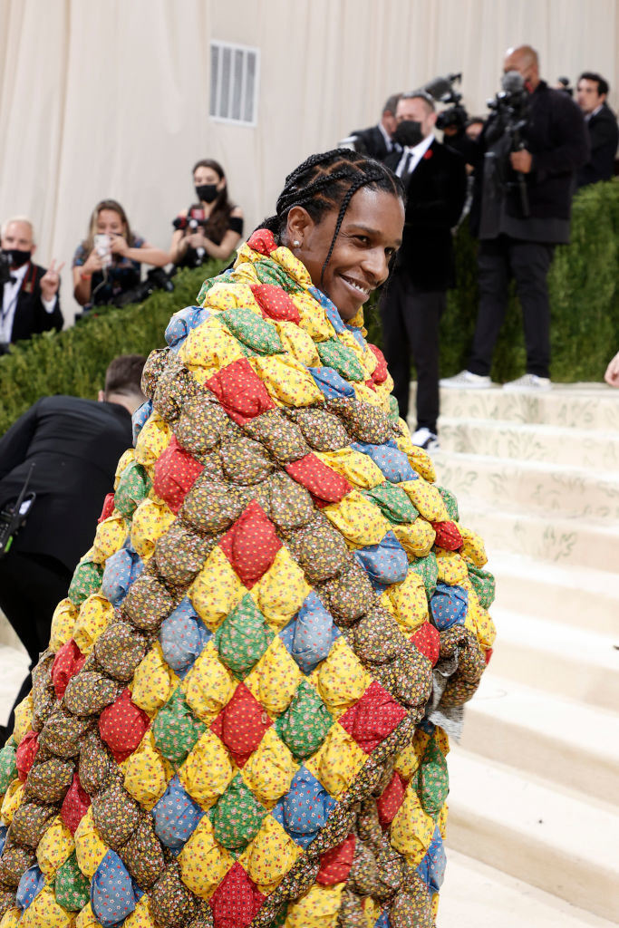 A$AP Rocky smiles while walking up the Met Gala stairs