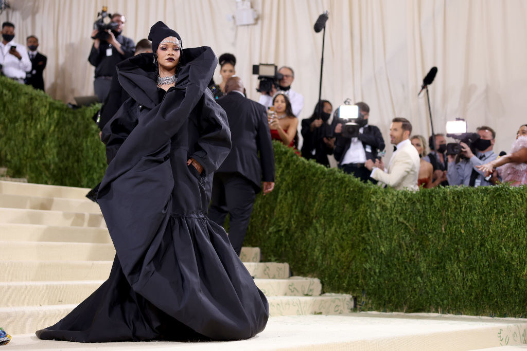 Rihanna wears an oversized gown with a high neck collar