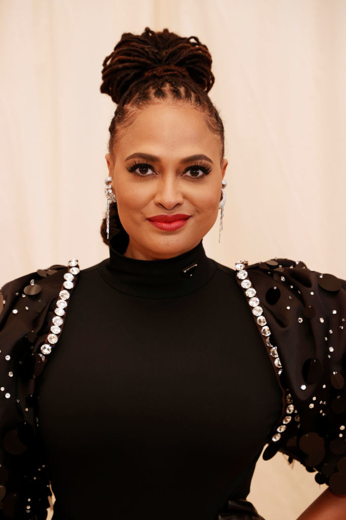 A close up of Ava DuVernay as she shows off her winged eyeliner and bold lipstick