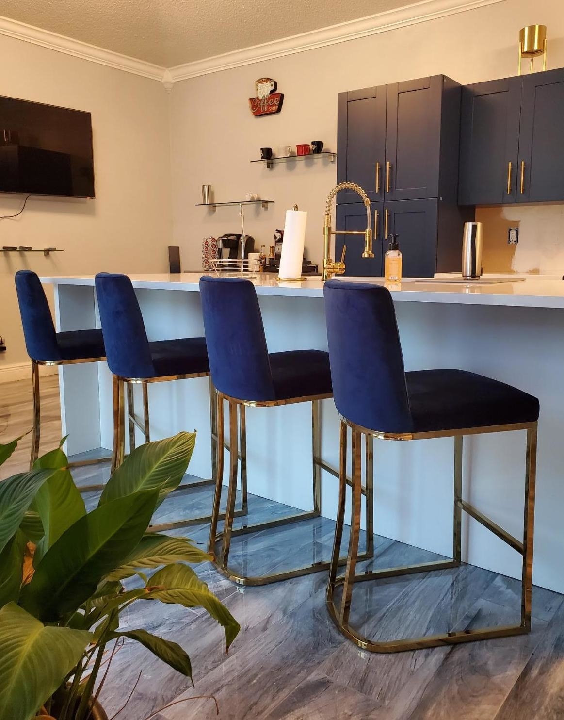 Reviewer&#x27;s navy blue and gold bar stools are shown in the kitchen