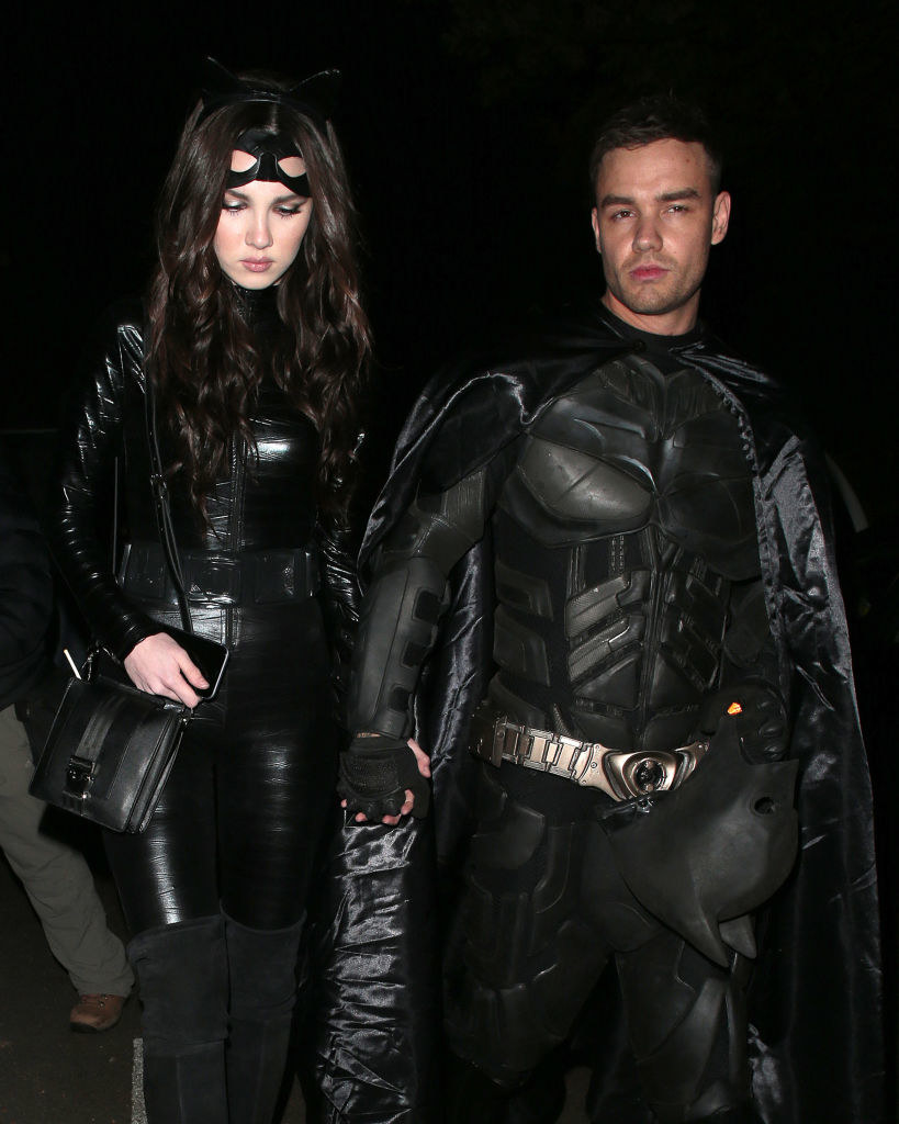 Liam Payne wears a Batman costume and Maya Henry wears a Catwoman costume