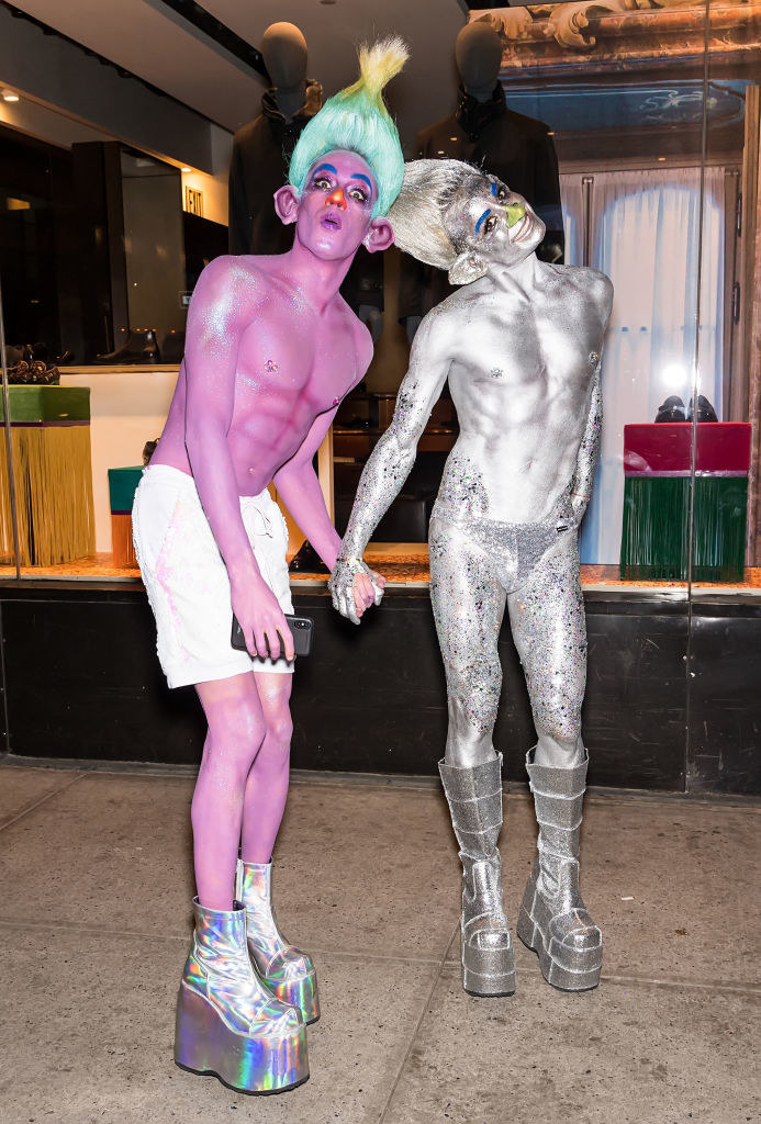 Frankie Grande and Daniel Sinasohn are shirtless covered in brightly colored body paint and glitter