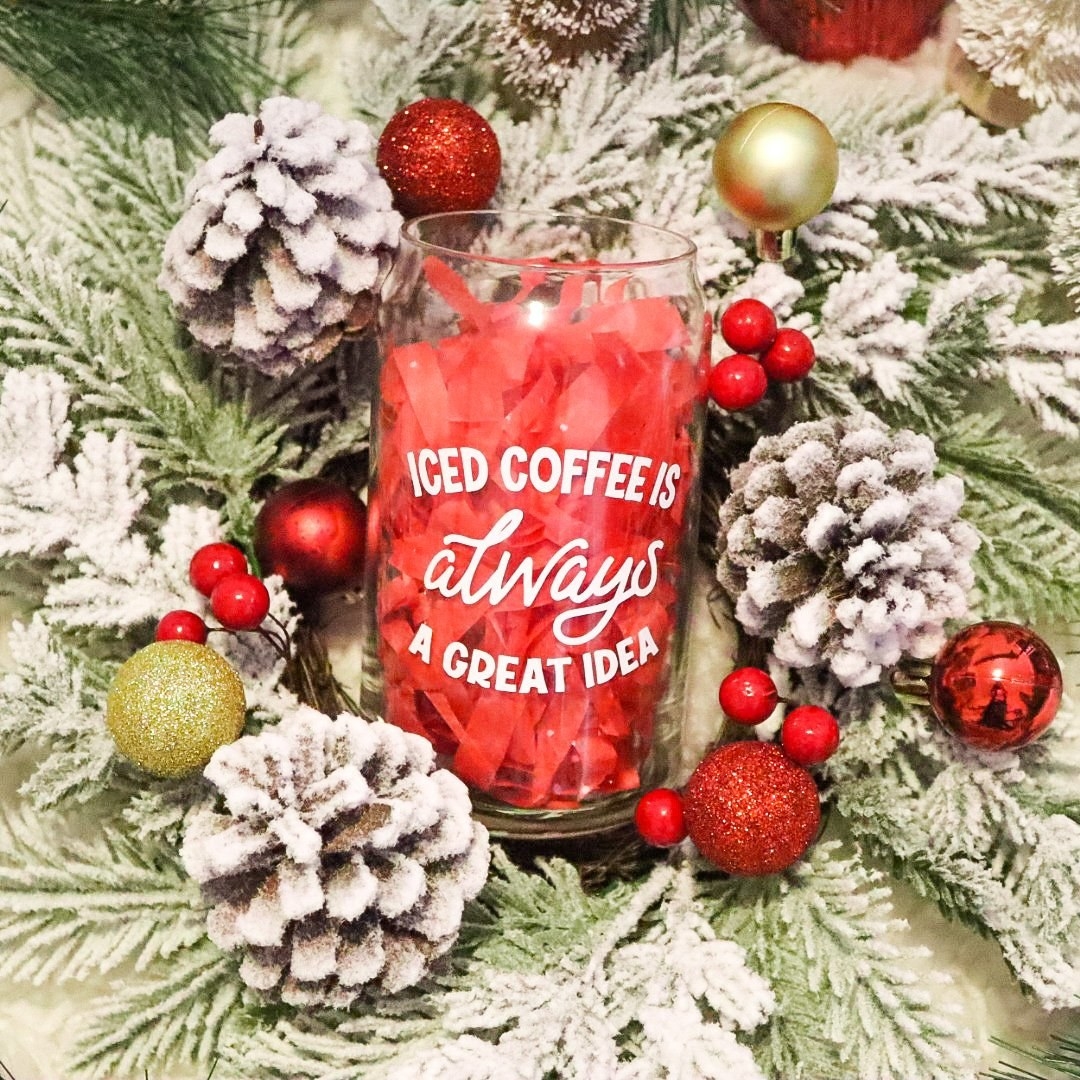 the glass in a bed of holly and frosted pinecones