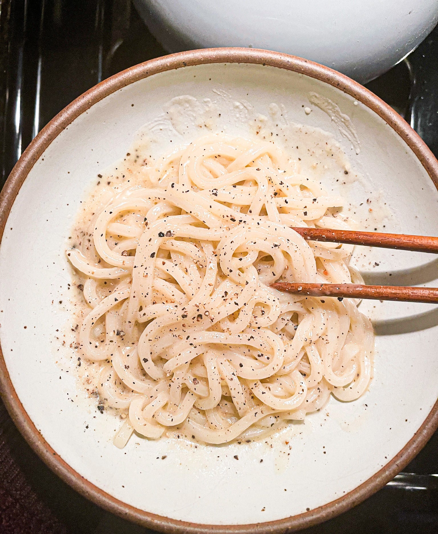 Udon noodles in a white bowl